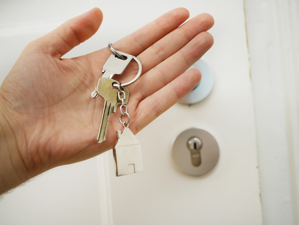 A person is holding their new apartment keys